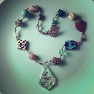 Turquoise bird pendant necklace, artistic design.